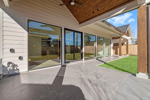 unfurnished sunroom featuring ceiling fan, lofted ceiling, and wood ceiling