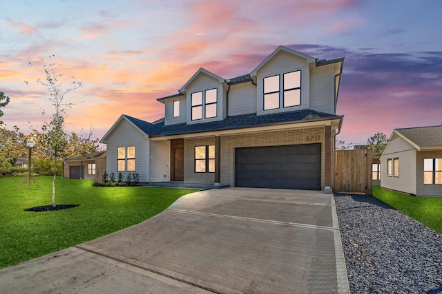 view of front of house with a garage and a lawn