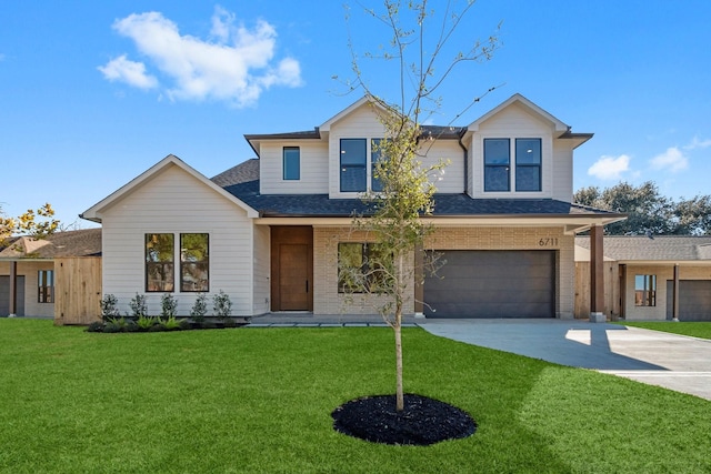 view of front of house with a garage and a front lawn