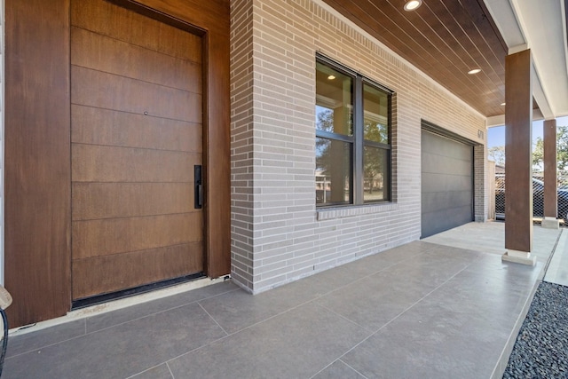 property entrance featuring a porch and a garage