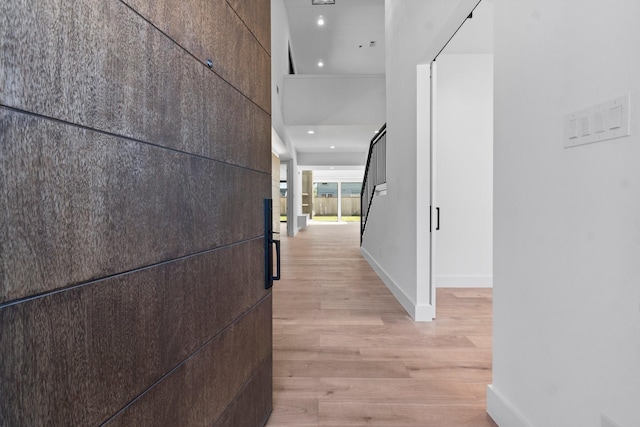 hallway with light hardwood / wood-style floors