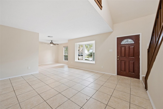 tiled foyer featuring ceiling fan