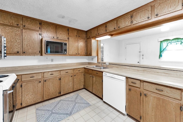 kitchen with dishwasher, sink, a textured ceiling, range, and black microwave