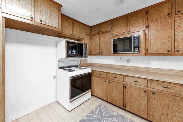 kitchen with electric stove, a textured ceiling, and black microwave