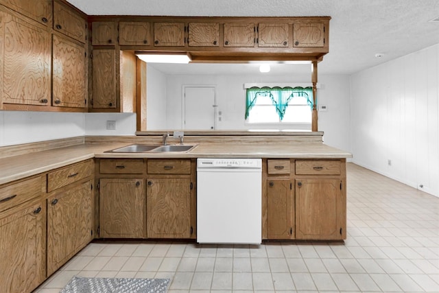 kitchen featuring sink, a textured ceiling, and white dishwasher