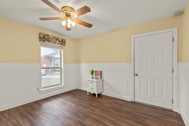 spare room with ceiling fan and dark hardwood / wood-style flooring