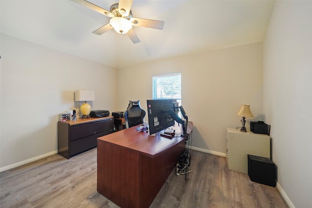 office area featuring light hardwood / wood-style flooring, vaulted ceiling, and ceiling fan