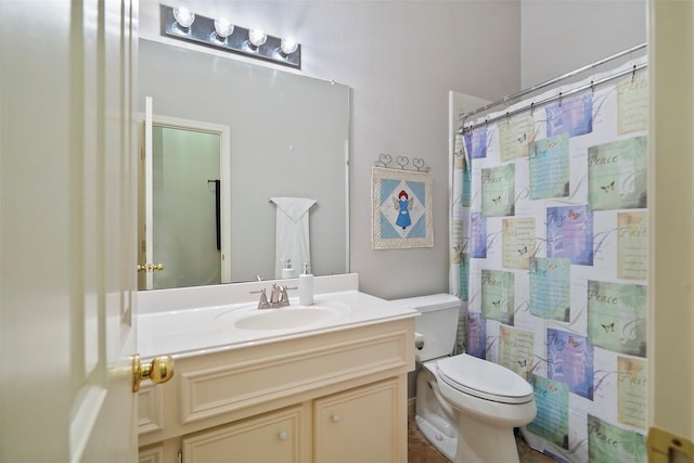 bathroom featuring toilet, vanity, and a shower with shower curtain