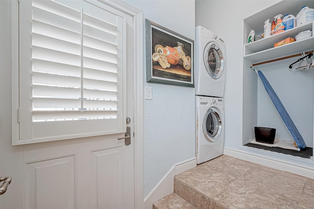 clothes washing area featuring stacked washer / drying machine