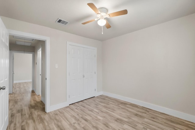 unfurnished bedroom with a closet, ceiling fan, and light wood-type flooring