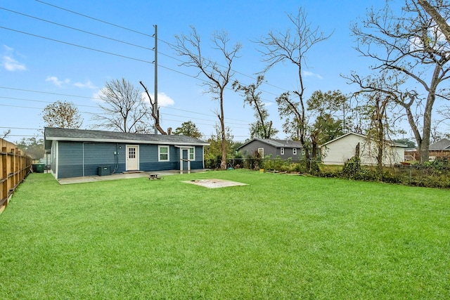 back of property with a patio area, a lawn, and central AC