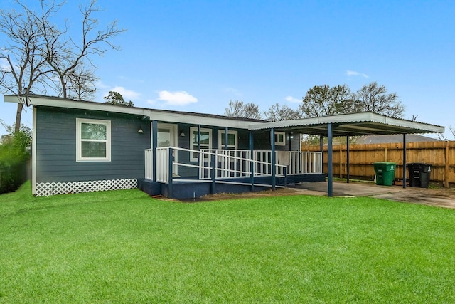 rear view of property with a porch and a yard