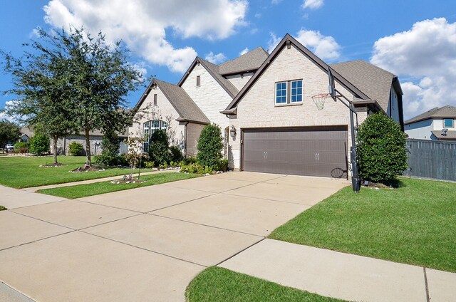 view of front of house featuring a garage and a front yard