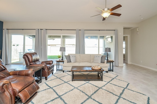 living room featuring a healthy amount of sunlight and ceiling fan