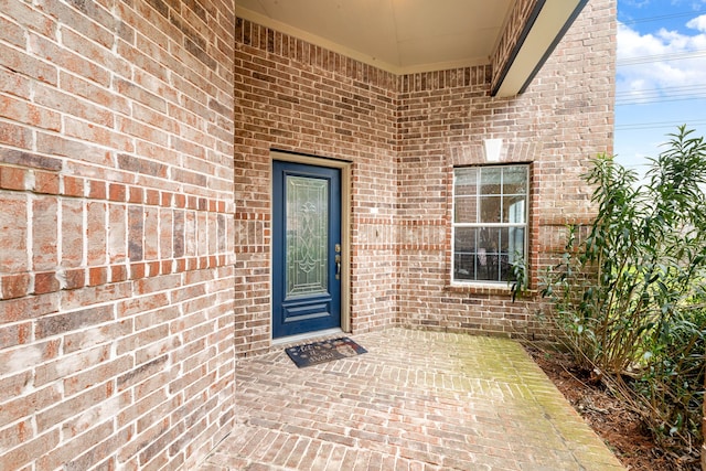 entrance to property featuring a patio