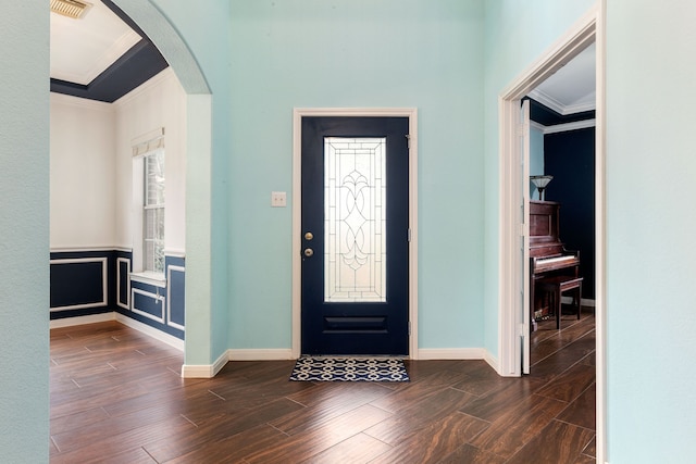 entrance foyer featuring dark hardwood / wood-style flooring, plenty of natural light, and ornamental molding