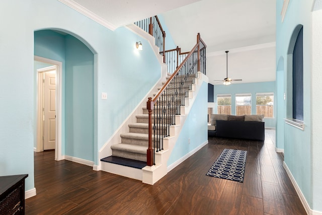 staircase featuring ornamental molding, ceiling fan, and hardwood / wood-style floors