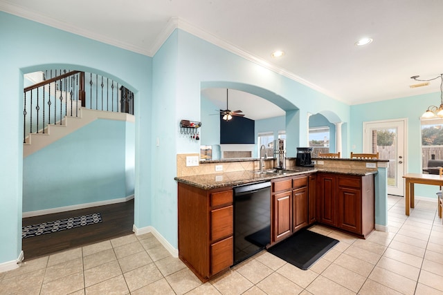 kitchen featuring kitchen peninsula, dark stone countertops, sink, black dishwasher, and ornamental molding