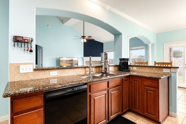 kitchen with kitchen peninsula, dishwasher, sink, dark stone counters, and light tile patterned flooring