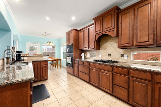 kitchen with black appliances, light tile patterned floors, sink, ornamental molding, and dark stone counters