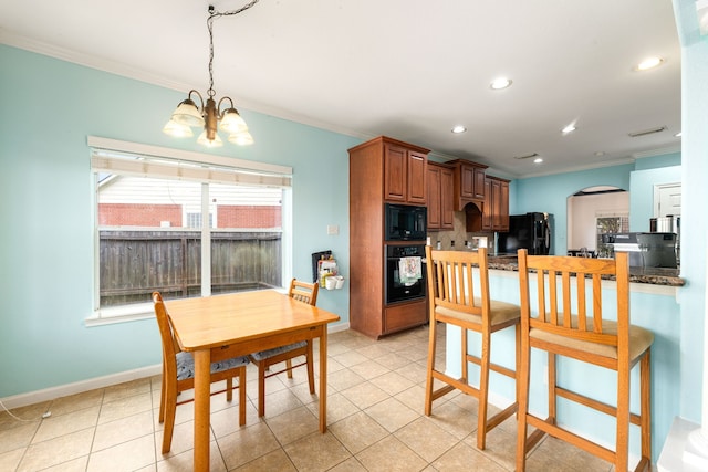 kitchen featuring pendant lighting, black appliances, a chandelier, light tile patterned floors, and crown molding