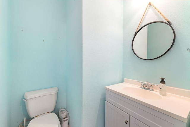 bathroom with toilet and vanity