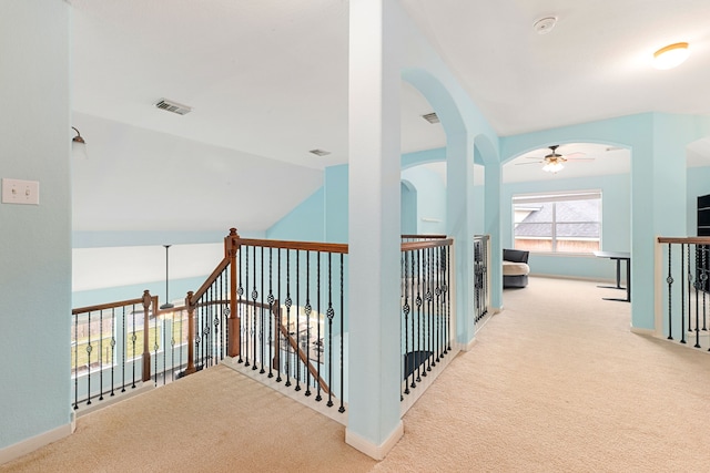 corridor featuring light carpet and lofted ceiling