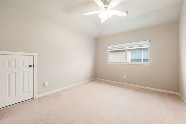 carpeted spare room with vaulted ceiling and ceiling fan