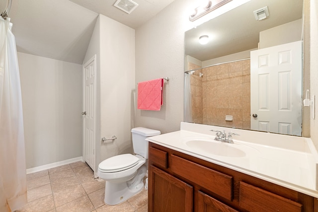 bathroom with toilet, vanity, and tile patterned flooring