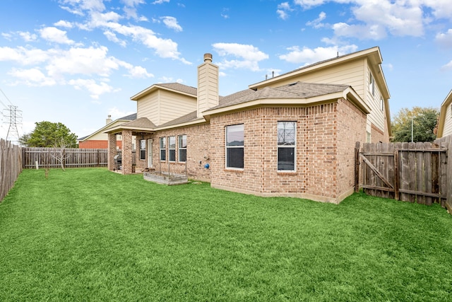 rear view of property featuring a lawn