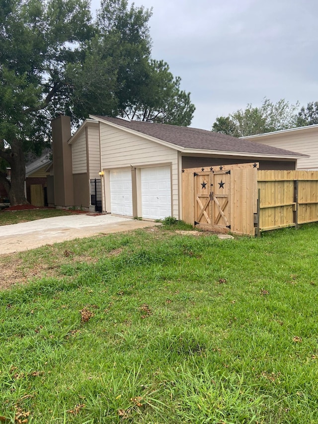 garage featuring a lawn