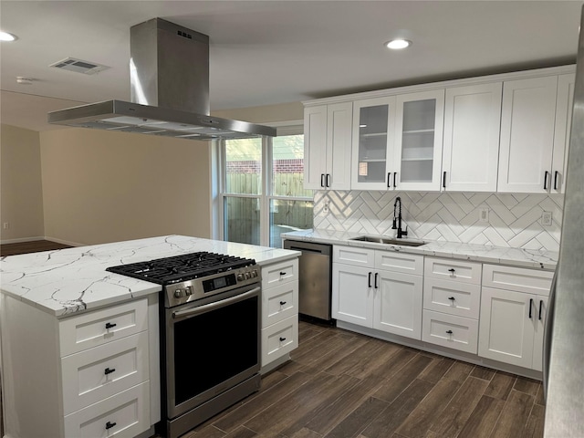 kitchen featuring sink, white cabinetry, island exhaust hood, and stainless steel appliances