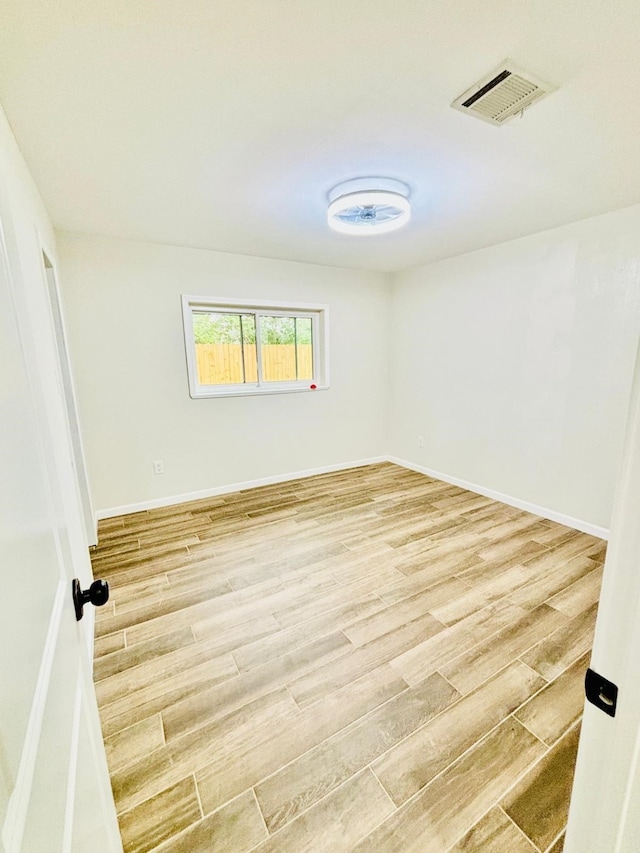 spare room with hardwood / wood-style flooring