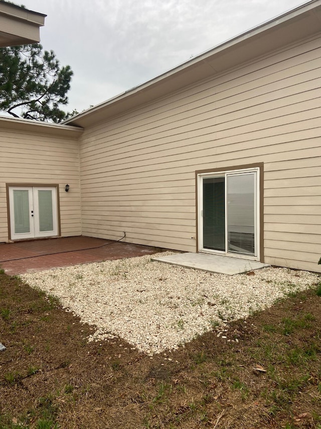 back of property featuring french doors and a patio