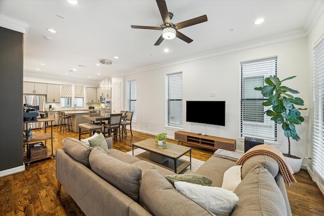 living room featuring crown molding, a healthy amount of sunlight, and dark hardwood / wood-style flooring