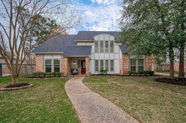 tudor-style house featuring a front yard