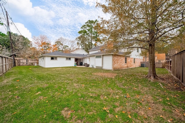 rear view of house featuring a yard