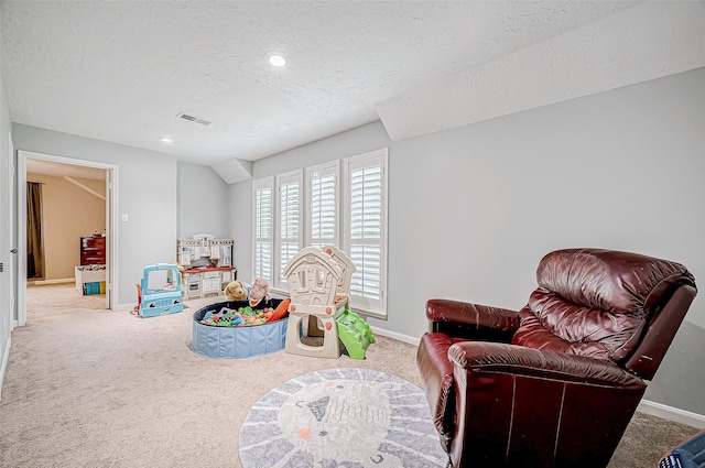 playroom featuring carpet floors and a textured ceiling