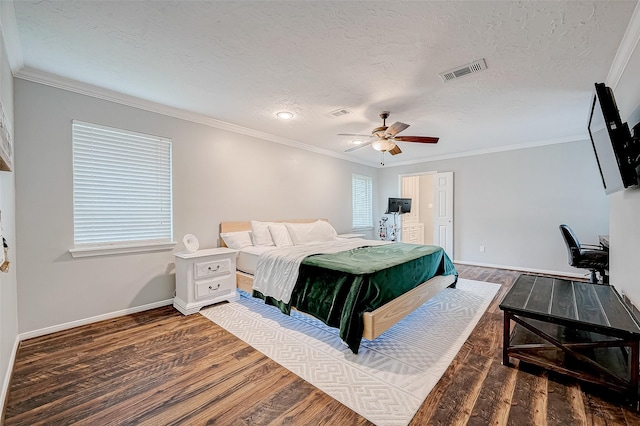 bedroom with ceiling fan, a textured ceiling, dark hardwood / wood-style flooring, and crown molding