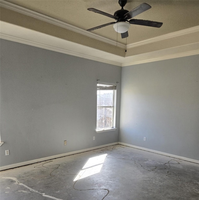 unfurnished room with ceiling fan, concrete floors, a raised ceiling, and crown molding