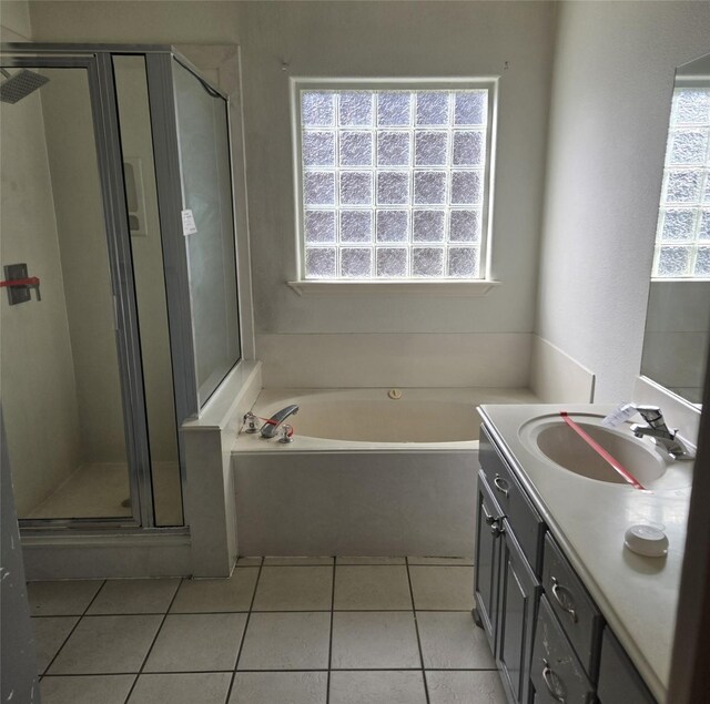 bathroom with plus walk in shower, tile patterned floors, and vanity