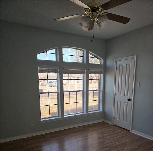 unfurnished room with hardwood / wood-style flooring, plenty of natural light, and ceiling fan