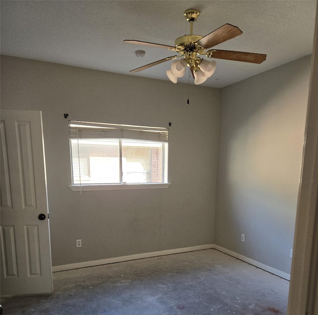 empty room with ceiling fan and concrete floors