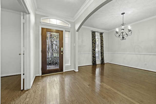 entryway with crown molding, dark hardwood / wood-style floors, and a wealth of natural light