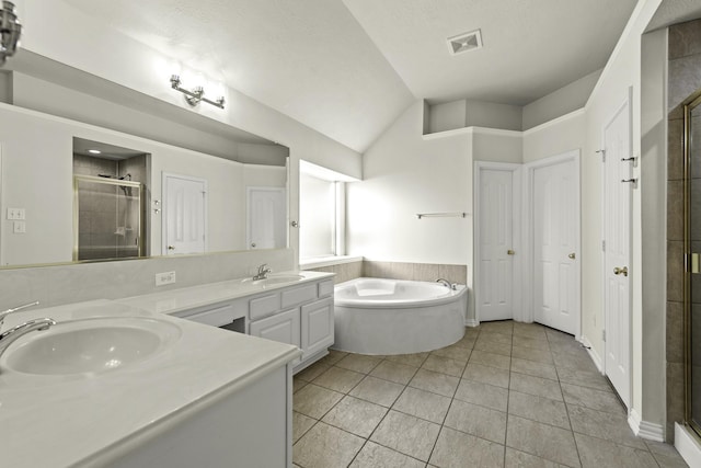 bathroom featuring tile patterned floors, vanity, lofted ceiling, and plus walk in shower