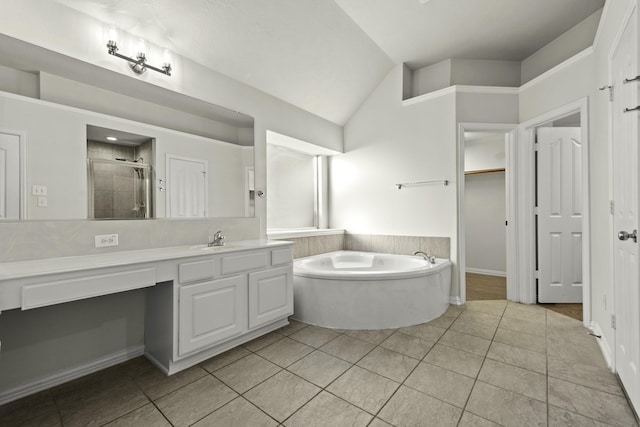 bathroom with plus walk in shower, tile patterned floors, lofted ceiling, and vanity