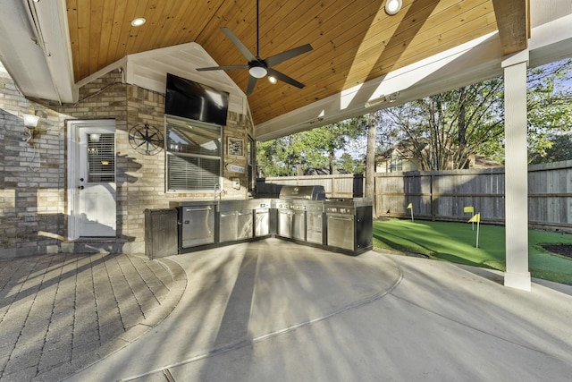 view of patio with ceiling fan, exterior kitchen, and area for grilling