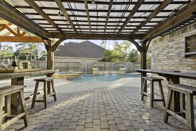 view of patio featuring a pool with hot tub, a pergola, and an outdoor bar