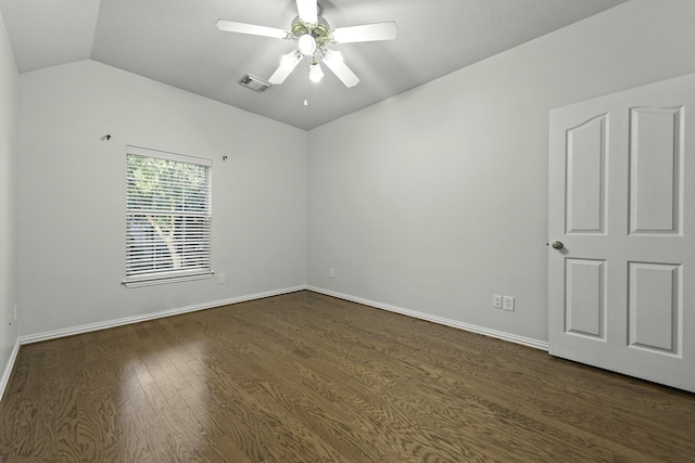 spare room featuring ceiling fan, dark hardwood / wood-style flooring, and lofted ceiling