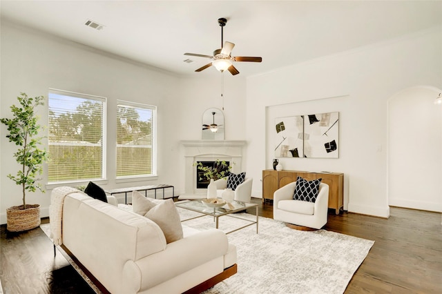 living room featuring ceiling fan and dark hardwood / wood-style flooring